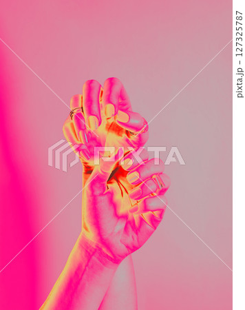 Pink Neon Hands with Rings Closeup. Infrared Thermal Image of two female hands. Manicure, hand and nail care concept. Pink Neon Hands with Rings Closeup. Infrared Thermal Image of two female hands. Manicure, hand and nail care concept. 127325787
