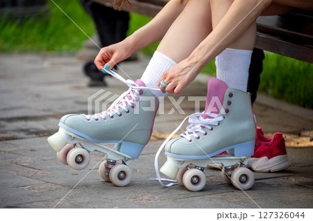 young woman with roller skates young woman with roller skates 127326044