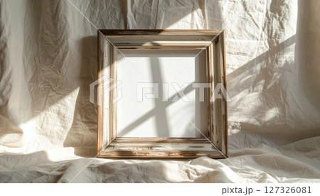 Empty White Frame on Beige Fabric with Sunlight Shadows 127326081