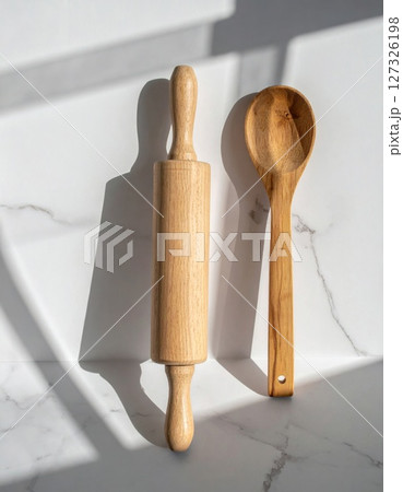 Wooden Rolling Pin and Spoon on Marble Surface Wooden Rolling Pin and Spoon on Marble Surface 127326198