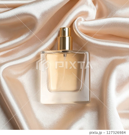 Gold Perfume Bottle on Beige Satin Fabric 127326984