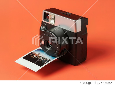 .Instant Camera Printing Photo on Orange Background, Modern Analog Photography, Retro Instant Film Technology, Creative Studio Still Life 127327062