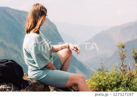 Woman Admiring Mountain View on Hiking Trip 127327197