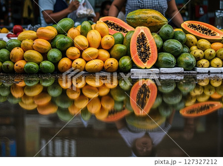 Colorful Fruit Stall Reflections in Tropical Outdoor Market After Rainfall 127327212