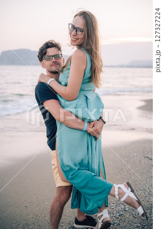 Happy Couple Embracing on a Sandy Beach Happy Couple Embracing on a Sandy Beach 127327224