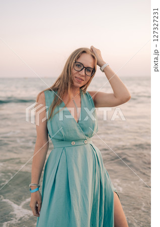 Woman in Flowing Dress on Seaside Pier Woman in Flowing Dress on Seaside Pier 127327231