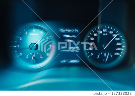 Blue dashboard display of a car going fast in traffic. 127328028