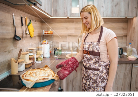 Joyful moments in the kitchen while baking a delicious pie Joyful moments in the kitchen while baking a delicious pie 127328051