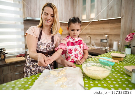 Baking sweet treats with joy in a cozy kitchen 127328058