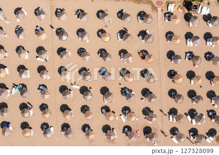 Aerial view to a sandy beach and sunshade with sunumbrellas 127328099