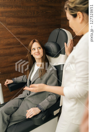 Vertical shot of medical specialist explaining pelvic floor muscle training, providing professional guidance, patient sitting on chair during consultation. Concept of innovative healthcare technology. Vertical shot of medical specialist explaining pelvic floor muscle training, providing professional guidance, patient sitting on chair during consultation. Concept of innovative healthcare technology. 127328651