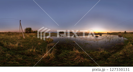 Spherical HDRi panorama of large swampy puddle near rustic dirt road at autumnal sunset Spherical HDRi panorama of large swampy puddle near rustic dirt road at autumnal sunset 127330131