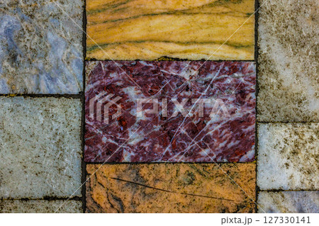 Worn Marble Floor Tile with Red, Yellow and White Tiles 127330141
