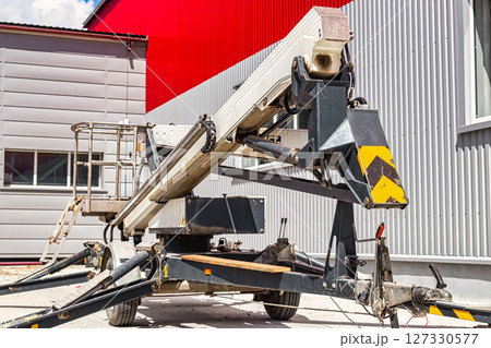 Construction telescopic tower or work platform for people to work at height. Powerful work platform for lifting construction workers up. 127330577