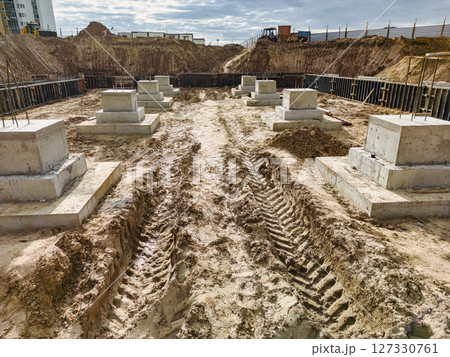 Monolithic reinforced concrete foundations or grillages for the construction of a large modern residential building. Rostverk at the construction site. Foundation for the building. View from above. 127330761