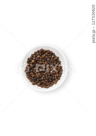 Black peppercorn in white bowl isolated Black peppercorn in white bowl isolated 127330920