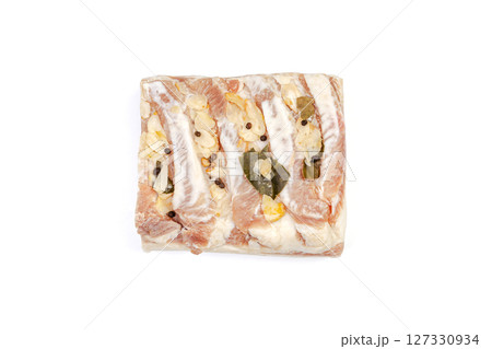 Lard or salo with bay leaf and black peas isolated on white background. 127330934