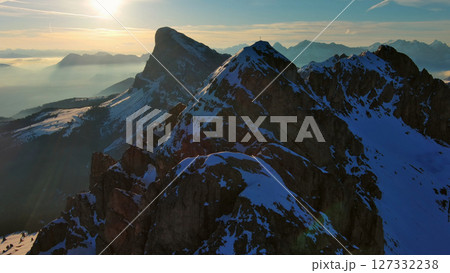 Rocky snow mountains at sunrise aerial 127332238