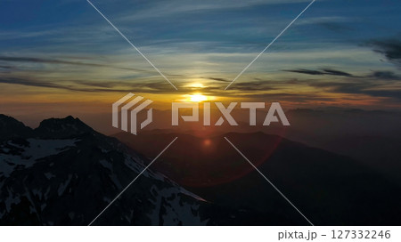 Rocky snow mountains at sunset aerial Rocky snow mountains at sunset aerial 127332246