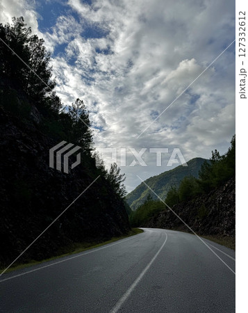 Mountainous road sky. Cloudy road landscape. High quality photo 127332612