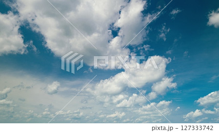 Time lapse. Breathtakingly Serene Sky Featuring Fluffy Clouds Set Against a Bright Blue Horizon 127333742