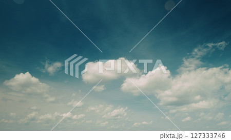 Time lapse. A Beautiful Sky Dominated by Fluffy Clouds Against a Bright Blue Background Provides Serenity 127333746