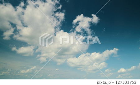 Time lapse. The Beautiful Skies are adorned with Fluffy Clouds drifting gracefully across the horizon 127333752