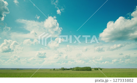 Time lapse. A Serene and Beautiful Landscape Featuring a Clear Blue Sky Accompanied by Cloud Patterns Time lapse. A Serene and Beautiful Landscape Featuring a Clear Blue Sky Accompanied by Cloud Patterns 127333802