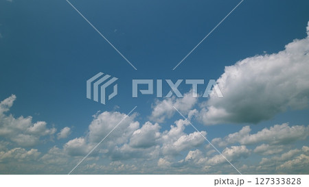 Time lapse. A Beautiful Serene Sky Filled with Fluffy Clouds in a Bright Blue Atmosphere Above Us Time lapse. A Beautiful Serene Sky Filled with Fluffy Clouds in a Bright Blue Atmosphere Above Us 127333828