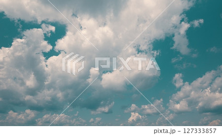 Time lapse. The beautiful skies have fluffy white clouds against a vibrant turquoise background Time lapse. The beautiful skies have fluffy white clouds against a vibrant turquoise background 127333857