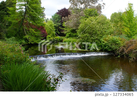 Small river waterfall in the park. Small river waterfall in the park. 127334065