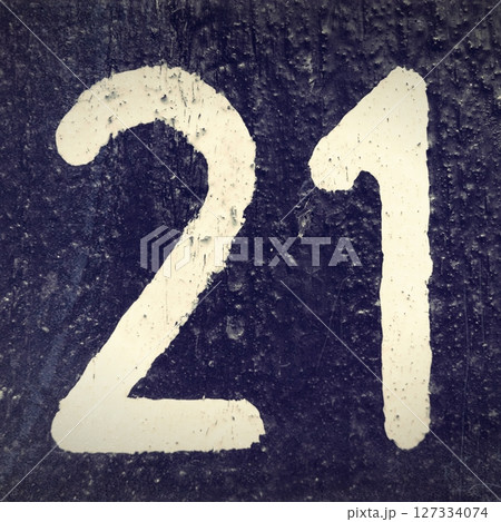 Number twenty one. White number on a dark background. Black and white old photo Number twenty one. White number on a dark background. Black and white old photo 127334074