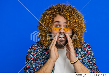 Caucasian young man whisper news rumors holding hands near mouth share gossip quiet keep my secrets 127334413