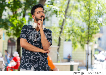 Thoughtful pensive puzzled Indian man with pensive expression pondering a solution doubting question Thoughtful pensive puzzled Indian man with pensive expression pondering a solution doubting question 127334749