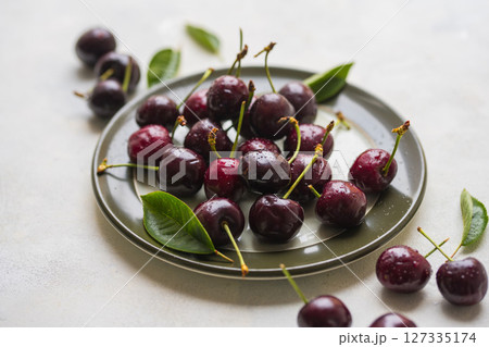 Fresh cherries fruits in a plate, top view, summer fruits. Abstract fruit food photo Fresh cherries fruits in a plate, top view, summer fruits. Abstract fruit food photo 127335174
