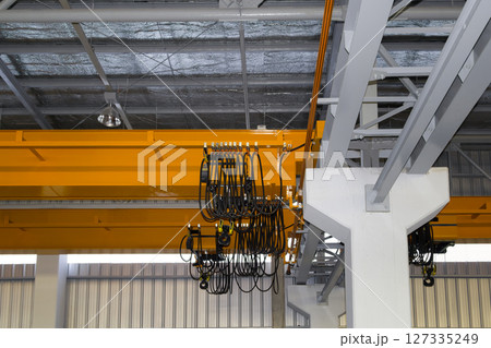 Overhead crane or lifting equipment inside factory or warehouse. 127335249