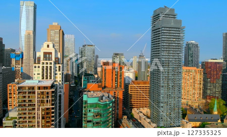 Toronto city skyline is slowly revealing with a panning movement, showcasing the cn tower and surrounding buildings and parks during a clear, sunny day. Urban style concept Canada 127335325