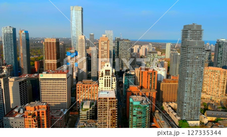 Toronto city skyline is displaying a mix of modern glass skyscrapers and traditional brick buildings, showcasing the city's architectural diversity and urban development. Urban style concept USA Toronto city skyline is displaying a mix of modern glass skyscrapers and traditional brick buildings, showcasing the city's architectural diversity and urban development. Urban style concept USA 127335344