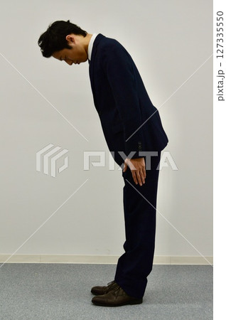 お辞儀をする若い男性 お辞儀をする若い男性 127335550