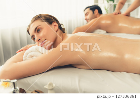 Caucasian couple customer enjoying relaxing anti-stress massage. Quiescent Caucasian couple customer enjoying relaxing anti-stress massage. Quiescent 127336861