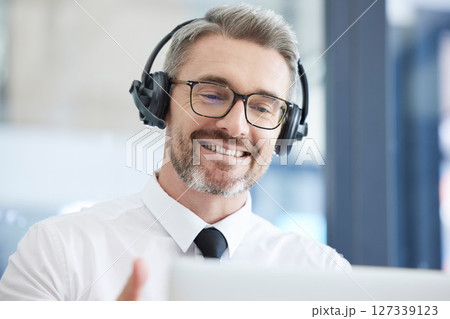 Call center, customer support and senior man talking to client in telemarketing, friendly service and crm company. Communication, contact us and male consulting agent with headset in customer service 127339123