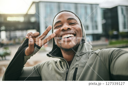 Fitness, selfie and man with peace sign in the city while doing a cardio exercise in Nigeria. Happy, smile and Nigerian guy taking picture while running for sports, race or marathon training in town. Fitness, selfie and man with peace sign in the city while doing a cardio exercise in Nigeria. Happy, smile and Nigerian guy taking picture while running for sports, race or marathon training in town. 127339127