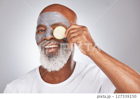 Skincare, face mask or happy old man with cucumber marketing or advertising natural vegan diet for glowing skin. Cream, portrait, senior black man with beauty or healthy anti aging facial cosmetics 127339150