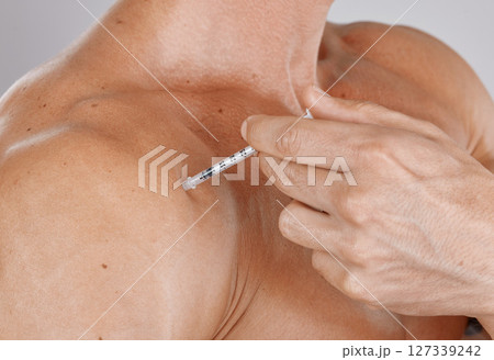 Closeup, man and botox injection, skincare and cosmetics with grey studio background. Male, guy and needle for serum, beauty and plastic surgery for body care, wellness and grooming for smooth skin 127339242