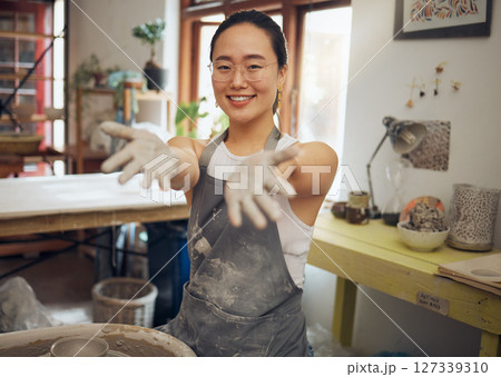 Portrait, clay pottery and Asian woman in studio, smile and sculpting for business, design art or creative. Hands, female entrepreneur or artist create ceramics, working on project or startup success 127339310