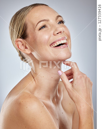 Beauty, skin and skincare with woman and happy with cosmetic treatment, glow and shine against studio background. Makeup, natural cosmetics and facial, face and body care with wellness and fresh. 127339416