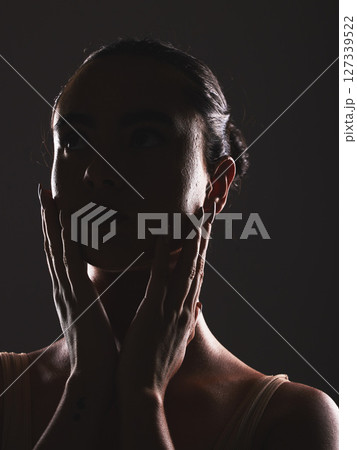 Woman, beauty and face silhouette in dark fantasy, cosmetics and dream aesthetics. Shadow, black background and model headshot while touching facial skin in mystery, studio background and erotic body Woman, beauty and face silhouette in dark fantasy, cosmetics and dream aesthetics. Shadow, black background and model headshot while touching facial skin in mystery, studio background and erotic body 127339522
