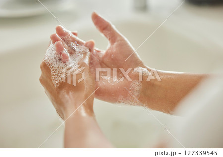 Woman, cleaning and hands with soap, bubbles or water in bathroom for hygiene, healthcare or safety. Hand washing, foam and clean from germs, virus or bacteria for wellness, healthy skin or self care Woman, cleaning and hands with soap, bubbles or water in bathroom for hygiene, healthcare or safety. Hand washing, foam and clean from germs, virus or bacteria for wellness, healthy skin or self care 127339545