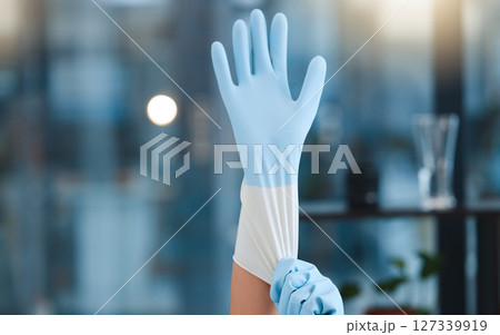 Hands, cleaning gloves and woman in home getting ready for hygiene at night. Spring cleaning, cleaning service and maid, worker or cleaner preparing to start washing or disinfection in dark house 127339919