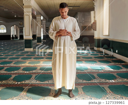 Man, muslim faith and praying in mosque for God, peace and mindfulness with traditional islamic clothes. Islam worship, prayer and spiritual balance for ramadan, religion and gratitude in Doha, Qatar 127339961
